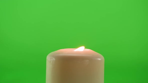 Burning Wax Candle on Green Chroma Key Background