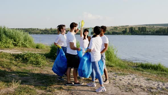 Multiracial Group of Young Volunteers Finish To