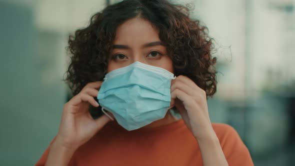 Close up of Young Attractive Indian woman wearing a medical mask