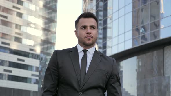 Pensive Young Businessman Walking for Meeting