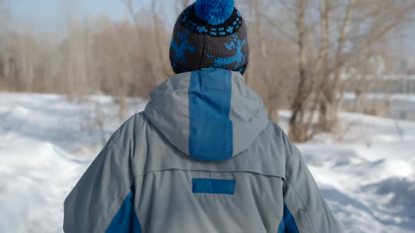 BACK VIEW: Portrait Of Elderly Woman Running In Winter Forest In The Sunshine - Slow motion