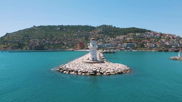 Awesome aerial view of Alanya Lighthouse (Alanya Deniz Feneri) in Turkey. Tourist ships and boats ar