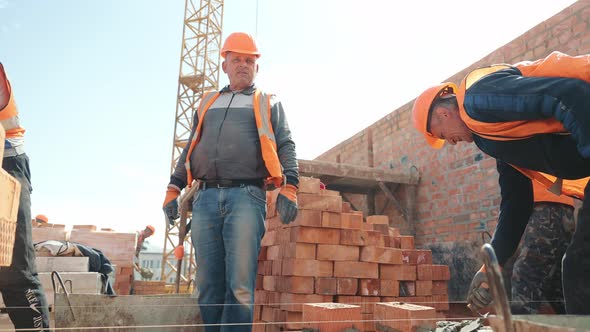 Builders Building a Brick Wall