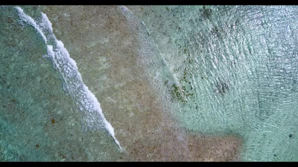 Aerial flying over texture of paradise bay beach voyage by shallow water with clean sandy background