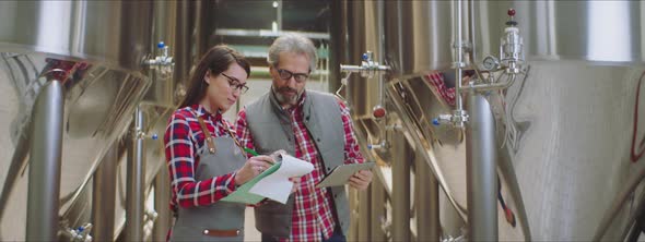 Two food technologists in a factory