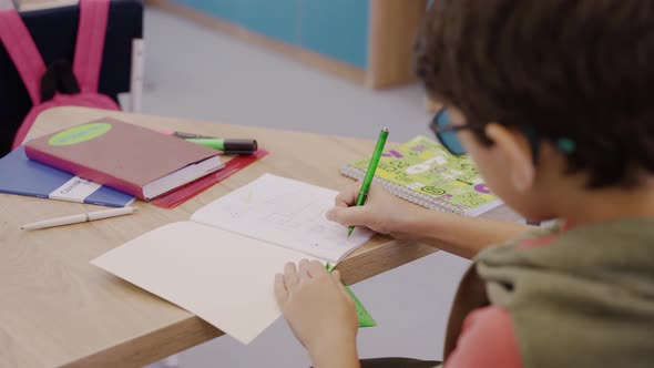 Careful Boy Drawing in Geometry Lesson with Ruler and Pencil Elementary School