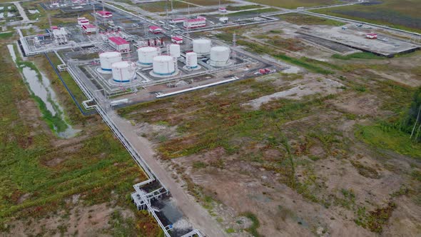 The Drone Flies Over Oil Tanks at the Oil Field and Primary Processing and Separation of Associated