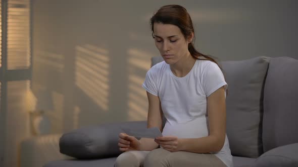 Depressed Lady Tearing Ultrasonographic Picture and Crying Unwanted Pregnancy