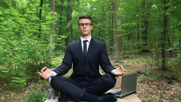 Businessman Sitting on Desk and Meditating in Fresh Air in Forest, Inspiration