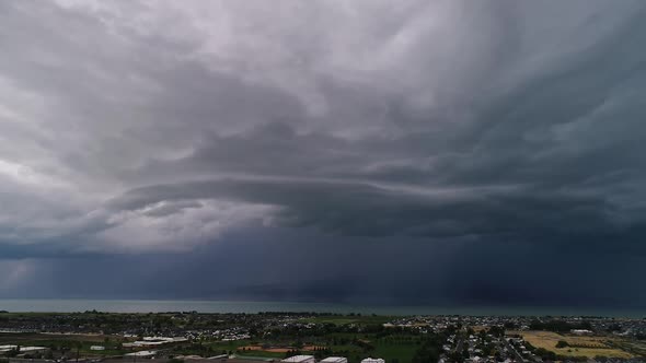 Panning aerial view of dramatic rain storm moving in over Utah Valley