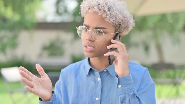 Portrait of Angry Young African Woman Talking on Phone