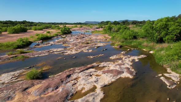 Aerial footage of the popular area on the Llano River in Texas called The Slab.  Water is low, expos