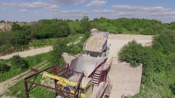 Aerial view of a dump truck loading ballast