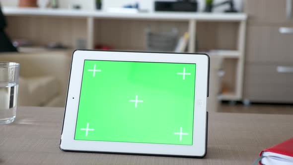 Digital Tablet PC with Green Screen Chroma Mockup on a Table