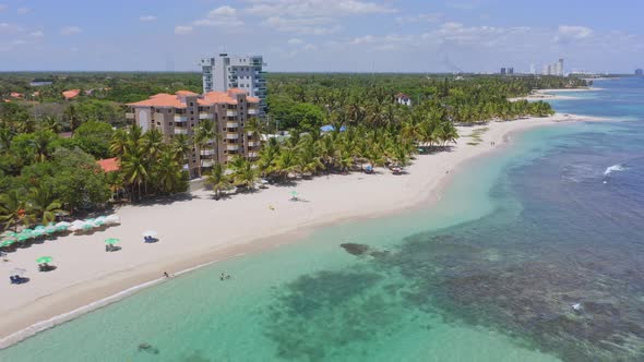 Crystal-clear Of Beach With Beachfront Hotels And Palm Trees On A Sunny Summer Day In Juan Dolio, Do