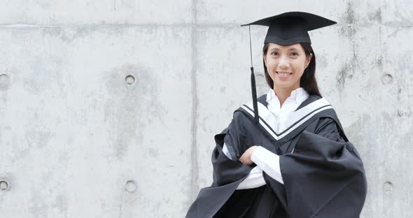 Asian woman get graduation gown
