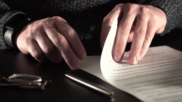 Close Up Shot of a Businessman Hands Who Looks Documents and Leave the Signature