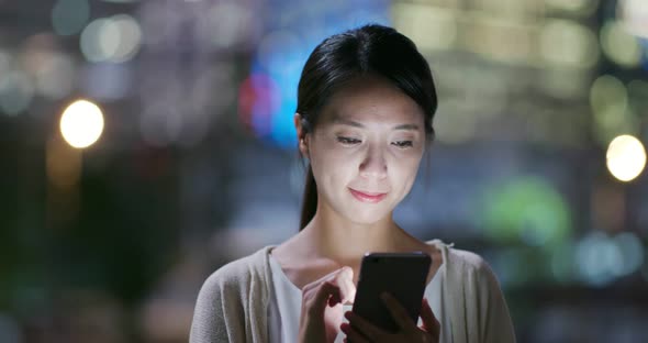 Woman use of cellphone at night