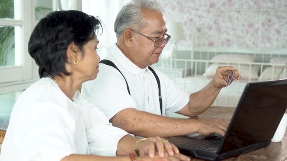 Happy Asian Couple Shopping Online Together