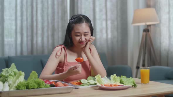 Asian Woman Holding Her Cheek And Shaking Her Head Due To Hating Eating Healthy Food