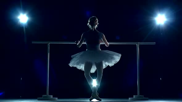 Young Ballerina Makes You Lean Forward. Back View. Slow Motion