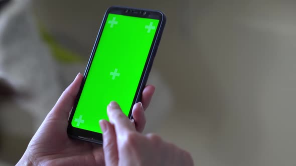 Young Woman at Modern Room Using Smartphone Mobile Phone with Green White