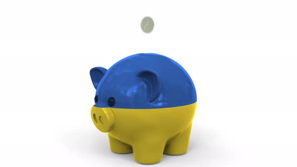 Coins Fall Into Piggy Bank Painted with Flag of Ukraine