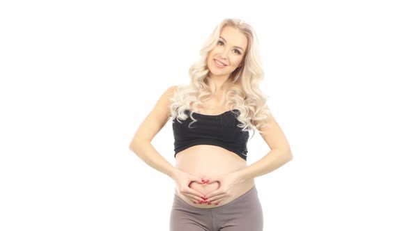 Pregnant Woman Holding Her Hands in a Heart Shape on Her Baby Bump, White