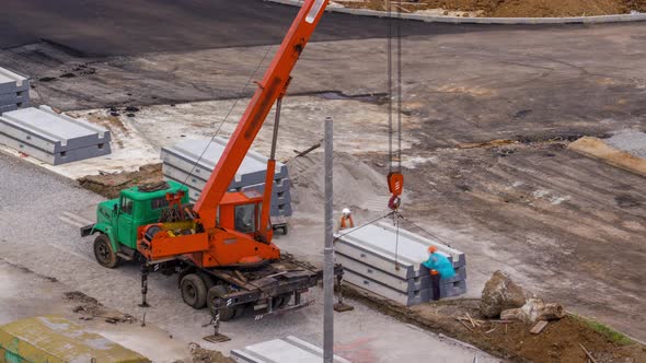 Installing Concrete Plates By Crane at Road Construction Site Timelapse