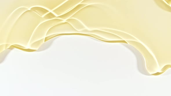 Yellow Transparent Cosmetic Gel Fluid With Molecule Bubbles Flowing On The Plain White Surface