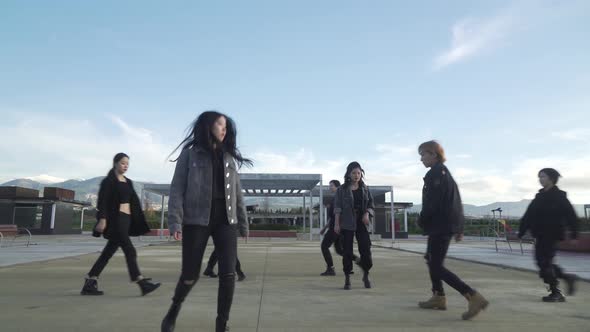 Young STREET PERFORMER performing on the street. Seven chinese teenagers dancing kpop