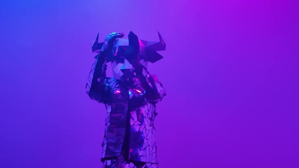 Shiny Silver Bull in Costume Made of Mirrors Dancing on Neon Blue Pink Studio Background