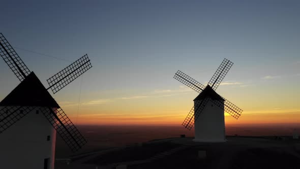 Aerial view of windmills in the countryside in Spain at sunrise