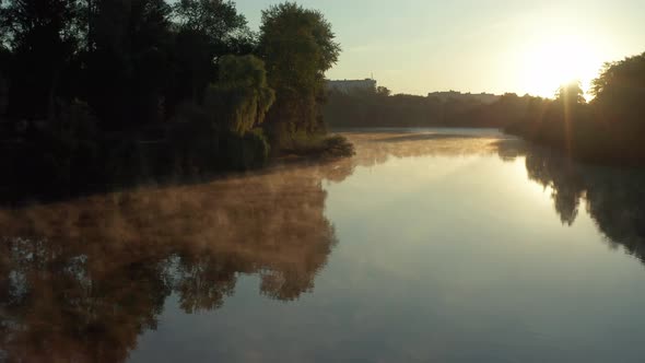 Beautiful morning, summer flight over the river. Fog, trees.