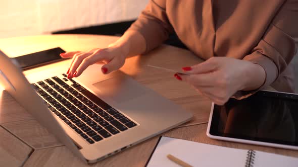 Female Hands Typing Credit Card Number on Computer Keyboard