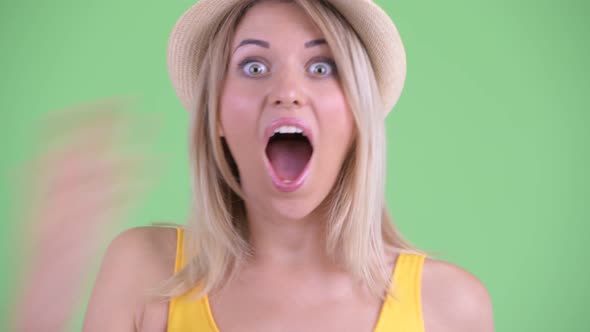 Face of Happy Young Blonde Tourist Woman Looking Surprised