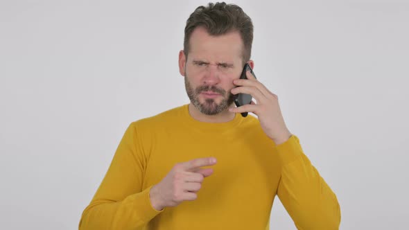 Portrait of Angry Middle Aged Man Talking on Smartphone
