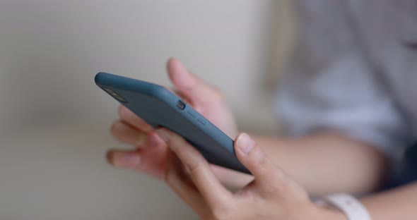 Close up Of Woman Use of Mobile Phone and Sit on Couch