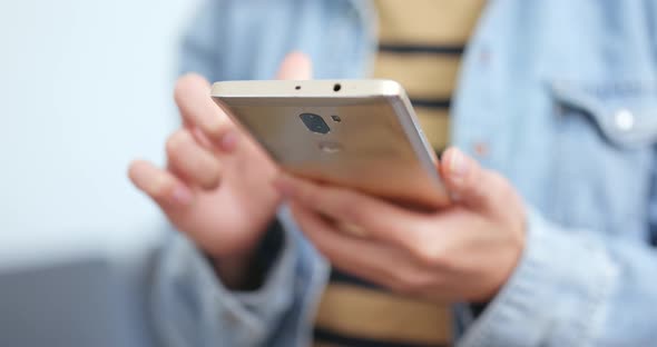 Woman using smart phone at home