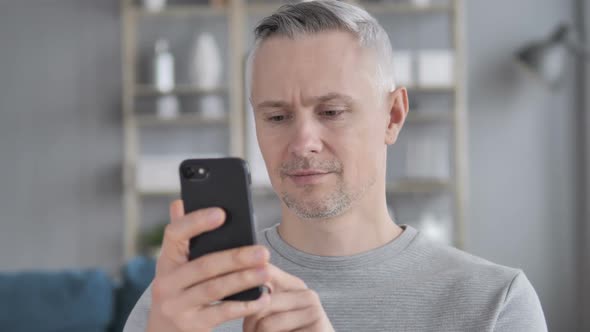 Portrait of Gray Hair Man Busy Using Smartphone