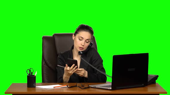 Woman at Workplace Is Working on Laptop, Talking on Two Phones and Sawing Nails. Green Screen