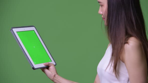 Young Beautiful Asian Businesswoman Showing Digital Tablet