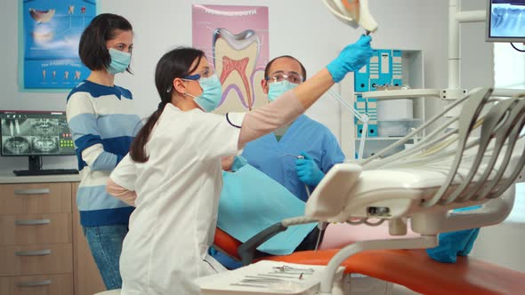 Little Girl Patient Sitting in Stomatological Chair in Dental Office