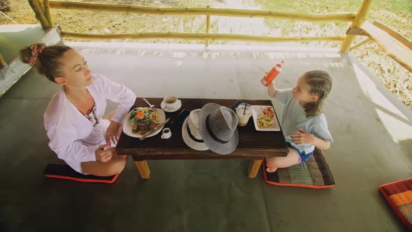 The Happy Family Eat and Drink Tasty Beverages Spending Time in Local Floating Cafe on Water