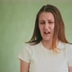 Stylish Woman Grimaces Demonstrating Disgusts on Green - VideoHive Item for Sale