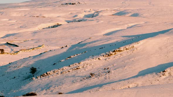 Time-lapse of the snow-covered hills near the Nine Standards Rigg in Cumbria, lit by the warm colour