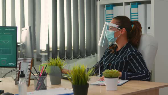 Manager with Protection Mask Working in New Normal Office