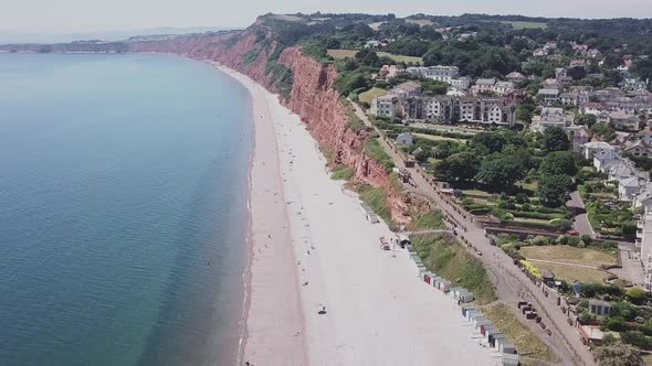Aerial STATIC CROP, flying toward red sandstone cliffs along the Jurassic Coast