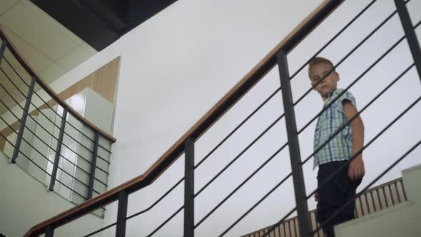 Pupil Walking Downstairs Inspecting School Hall