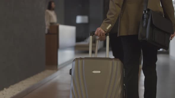 Couple Checking Out of Hotel